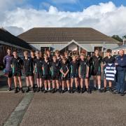 Rugby Coach Daley Jones and Wellbeing Officer Huw Williams with Welshpool high School Under 14s Rugby team.