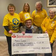 Fair organist George Morgan presented a cheque to members of Marie Curie's Newtown branch.