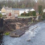 The garden wall collapsed into the River Tawe in Powys