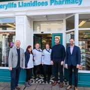 Cefin Campbell MS with staff at Llanidloes Pharmacy.