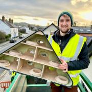 Elfyn Pugh helping to install the new boxes at Machynlleth co-op.
