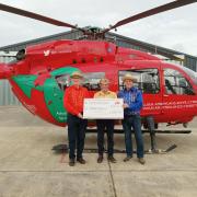 The Radnor Twurzels, including Gareth Price (left) and Jeff and Reg Evans, presenting the cheque at the Welshpool base.
