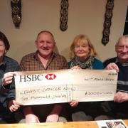 Mrs Menna Rowlands, Mr Emyr Roberts, Mrs Val Roberts and Mr Gwyndaf Evans  in the Goat Inn displaying the cheque that wil be sent to Breast Cancer Now