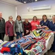 Mori Edwards, Aneurin Jones and Beryl Crone from the hospital's League of Friends, Made with Llani Love's Trudy Davies and Barbara Woosnam, and Sister Sara and Sister Vicky with the knitted blankets at Llanidloes Hospital.