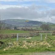 A National Grid Electricity Distribution helicopter flying low near Builth Wells.