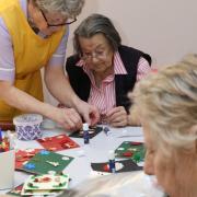 Cottage view care worker Grace Lewis helps residents in a craft workshop at the home.