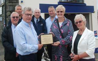 Aberystwyth Lifeboat Station present a memorial plaque to the family of Peter Martin Jones, of Newtown, who bequeathed £300,000 to the RNLI. Picture by RNLI.