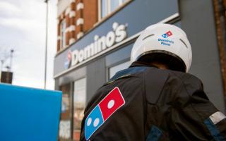 Domino's Pizza delivery driver outside one of the fast food chain's branches.