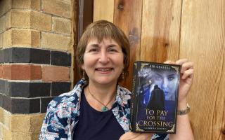 Kim Gravell with a copy of her book To Pay For The Crossing which was published last year.